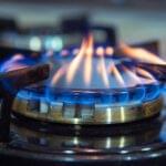 Blue flames on gas stove burner.